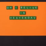 green letter tiles on an orange surface