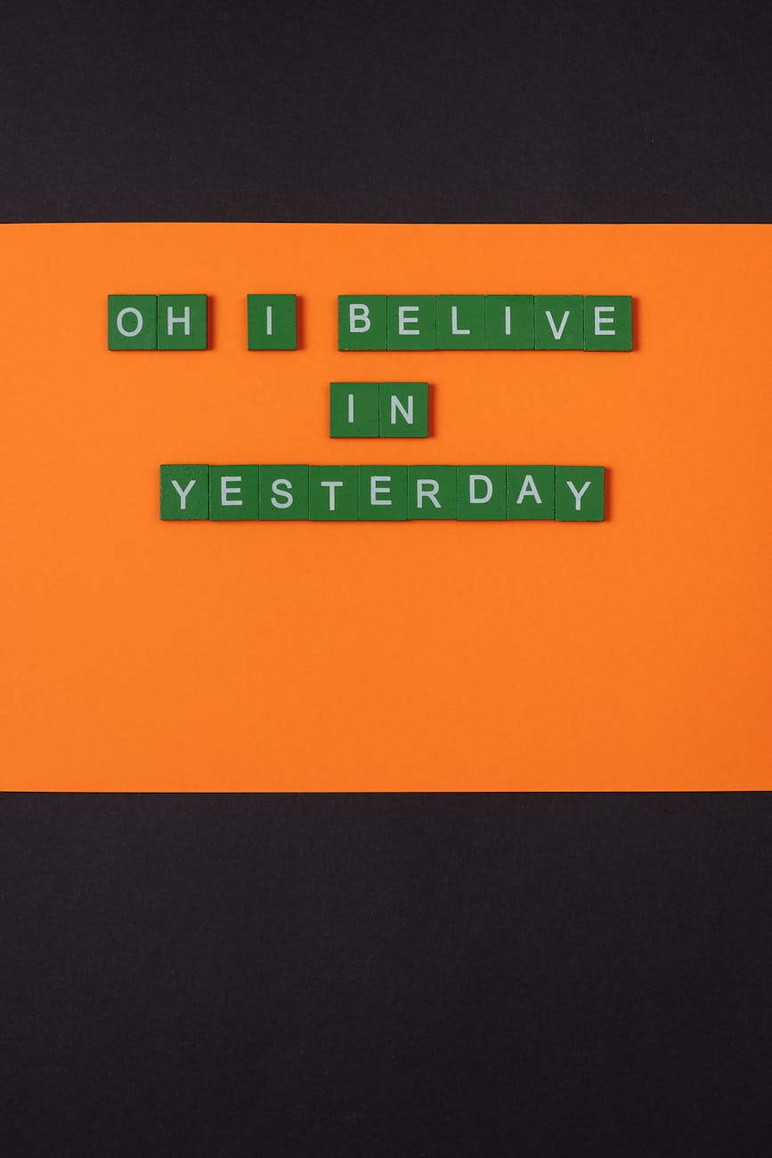 green letter tiles on an orange surface